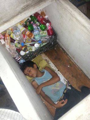 شاهد بالصورة.. طفل يمني يتسلل إلى داخل «ثلاجة البقالة» ليرتاح وينام قليلاً